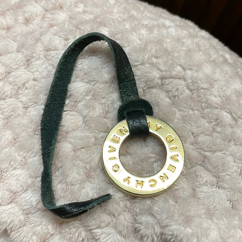 Givenchy gold charm on leather